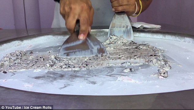 Street vendors then spread the mix thinly onto the cold metal plate for the next stage of making ice cream rolls