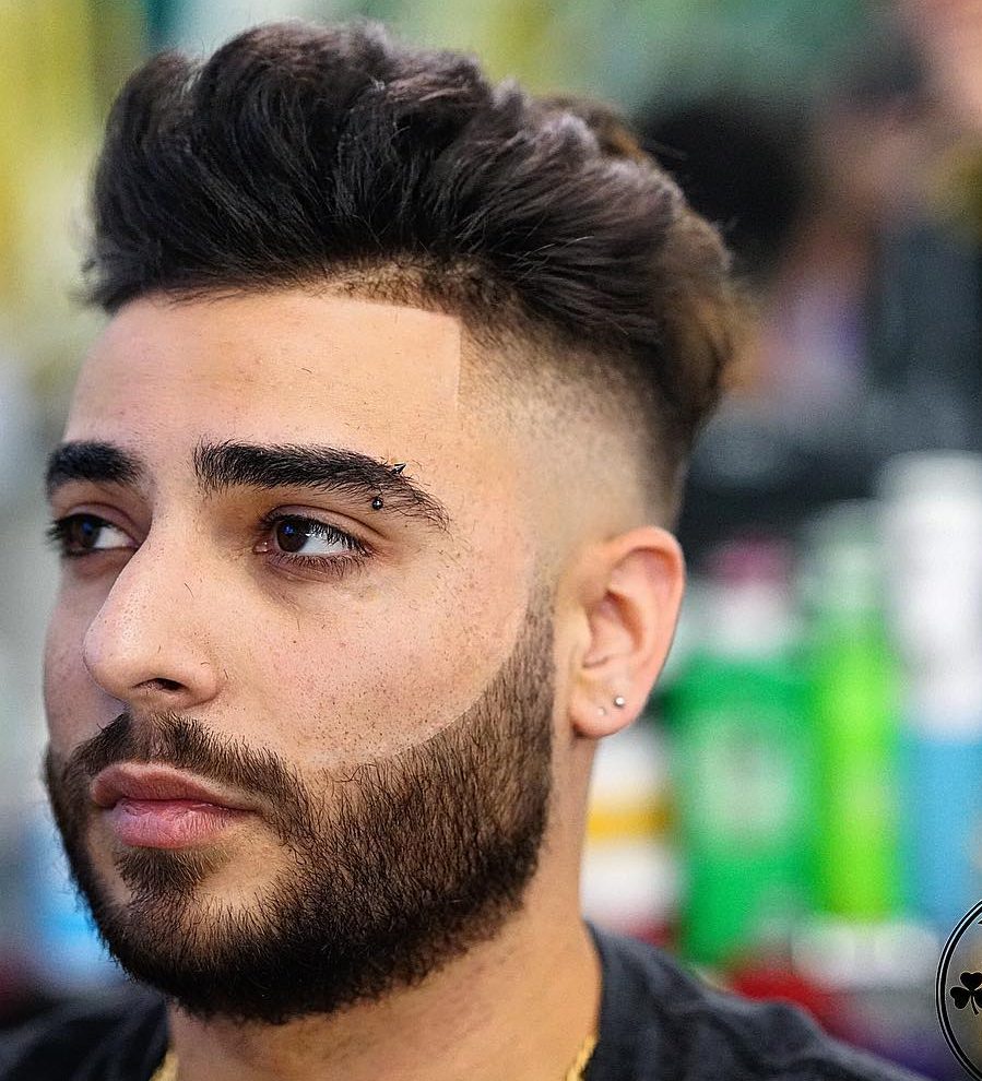 Textured pompadour hairstyle and bald fade with line up